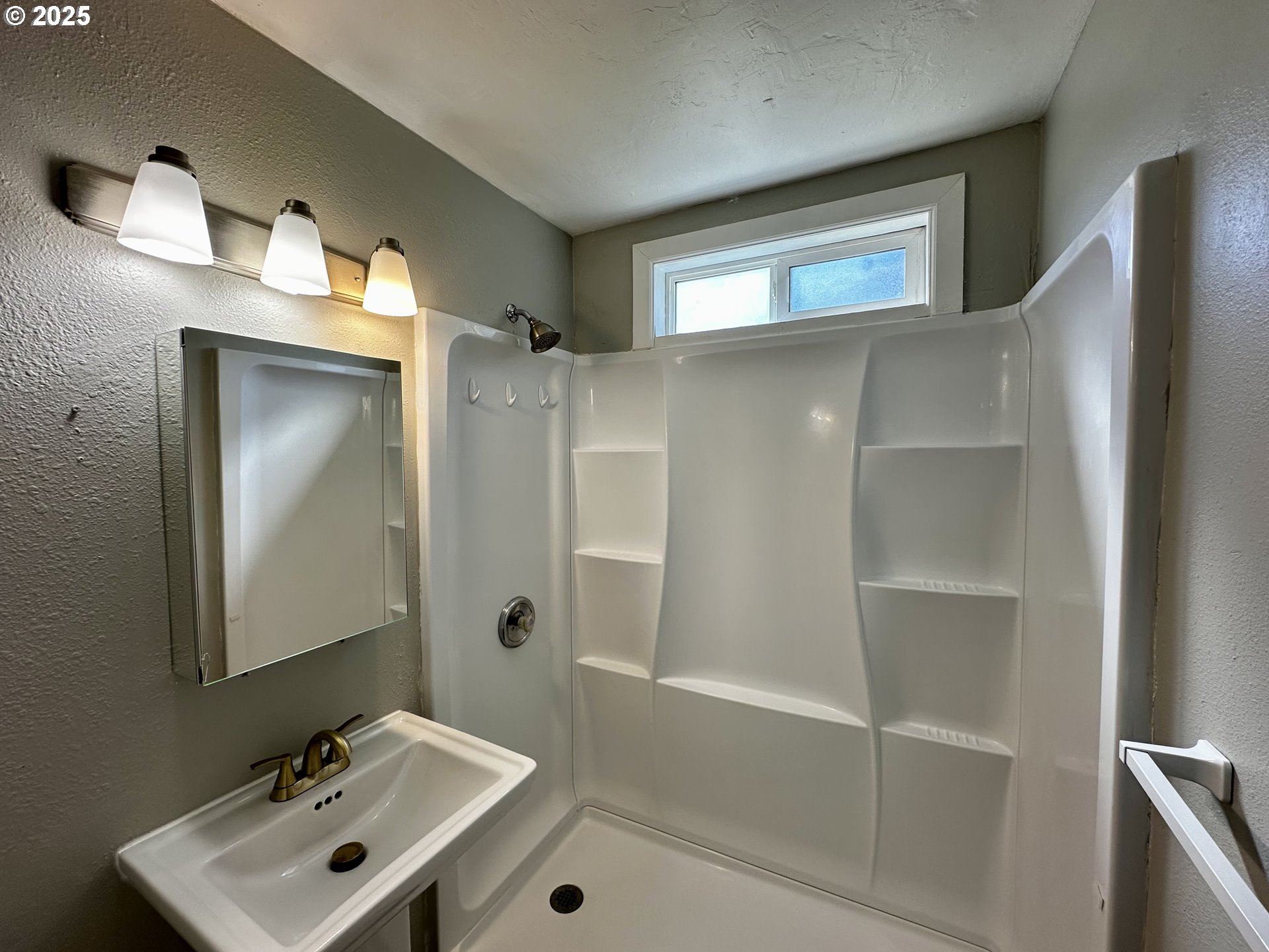 1733 I Street Springfield, OR 97477 - Photo 25 of 28 a bathroom with a sink a mirror and a shower