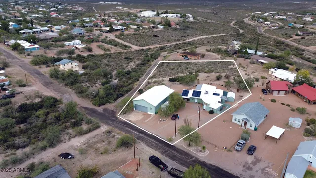 an aerial view of a house with a yard