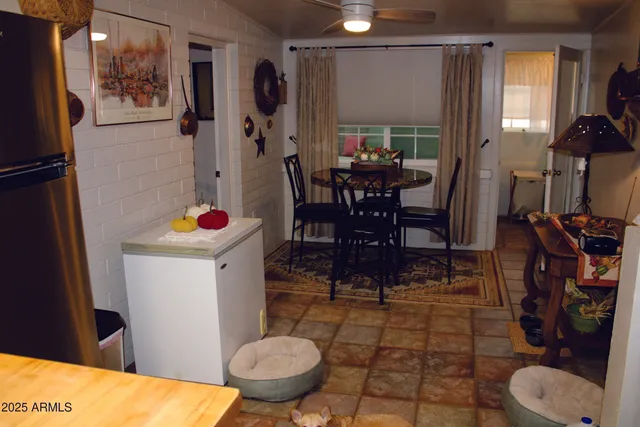 a work room with furniture and paintings on the wall