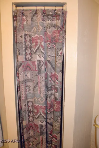 a view of balcony with two chairs and a potted plant