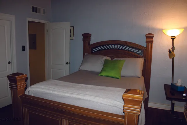 a bed sitting in a bedroom next to a window