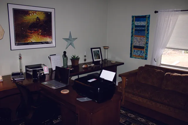 a view of a livingroom with furniture and chandelier fan
