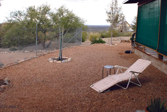 a backyard of a house with table and chairs