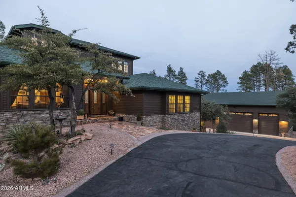 a view of a house with a patio and a yard