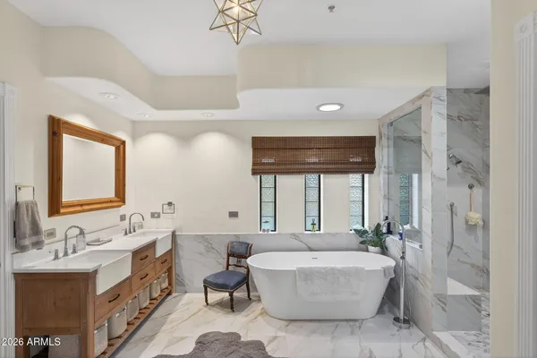 a spacious bathroom with a double vanity sink mirror and bathtub