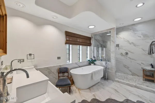 a spacious bathroom with a bathtub and sink