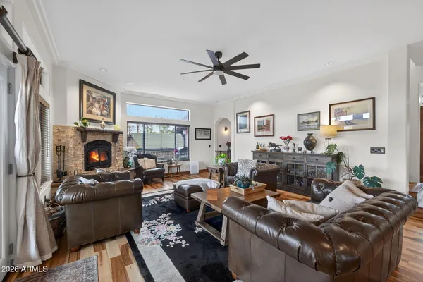a living room with furniture a fireplace and a flat screen tv