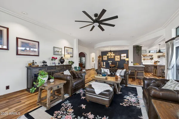 a living room with furniture a window and a ceiling fan