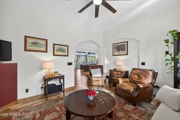 a living room with furniture and a wooden floor