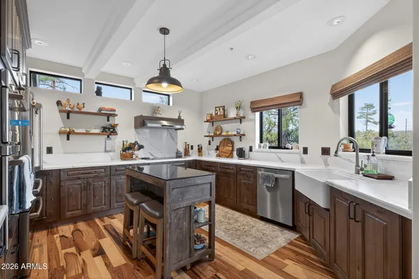 a kitchen with a stove a sink and a refrigerator