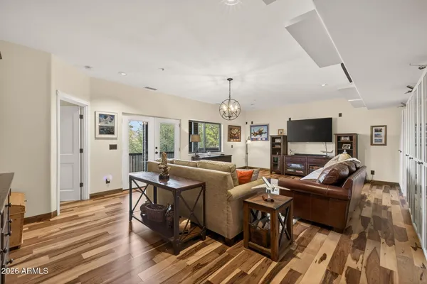 a living room with furniture or chandelier and a wooden floor
