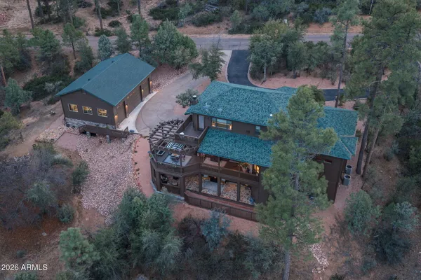 an aerial view of a house with garden space and street view