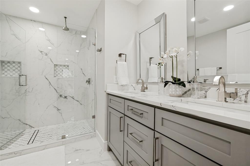 2006 Marydale Road Dallas, TX 75208 - Photo 26 of 40 Double vanity featuring undermount sinks, brushed nickel fixtures, and a marble-finish countertop