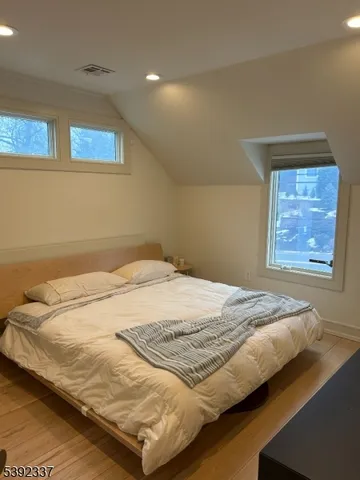 a bed sitting in a bedroom next to a window