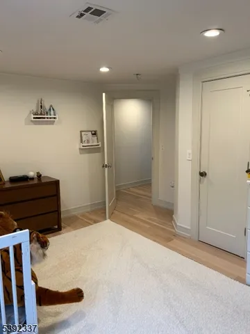a spacious bedroom with a bed and a dresser