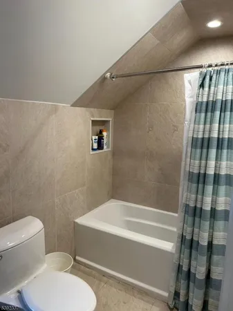 a bathroom with a toilet and a bathtub