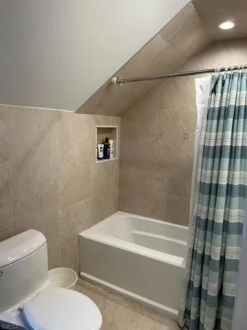a bathroom with a toilet and a bathtub