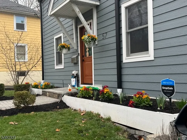 a view of a house with a yard and a garden