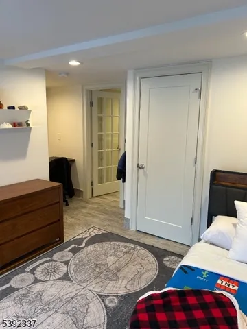 a bedroom with two beds and a dresser