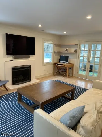 a living room with furniture fireplace and flat screen tv