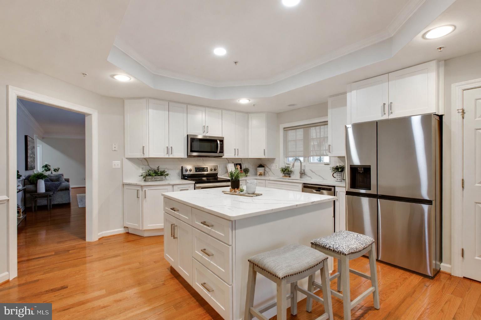 2610 Legends Way Ellicott City, MD 21042 - Photo 22 of 53 a kitchen with white cabinets and stainless steel appliances