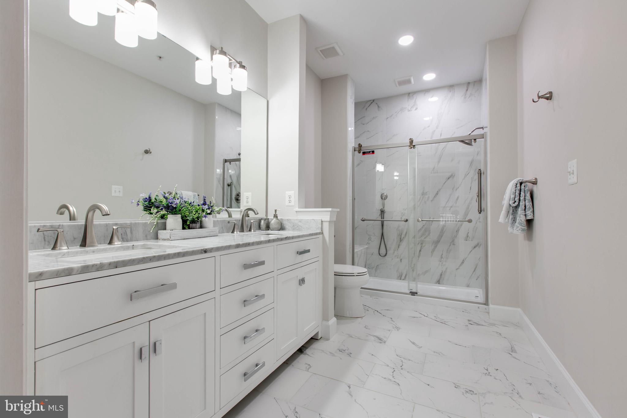 2610 Legends Way Ellicott City, MD 21042 - Photo 28 of 53 a spacious bathroom with a double vanity sink mirror and shower