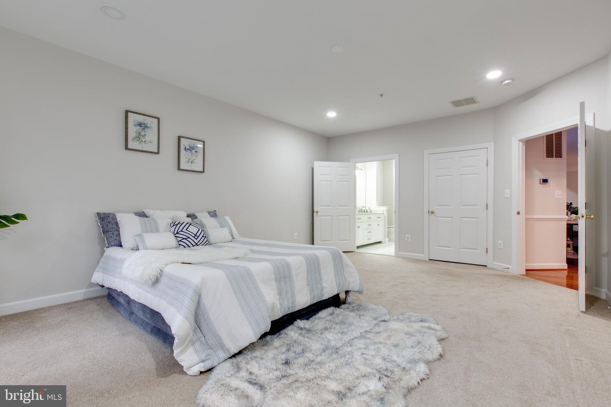 2610 Legends Way Ellicott City, MD 21042 - Photo 31 of 53 a spacious bedroom with a bed and a view of bathroom