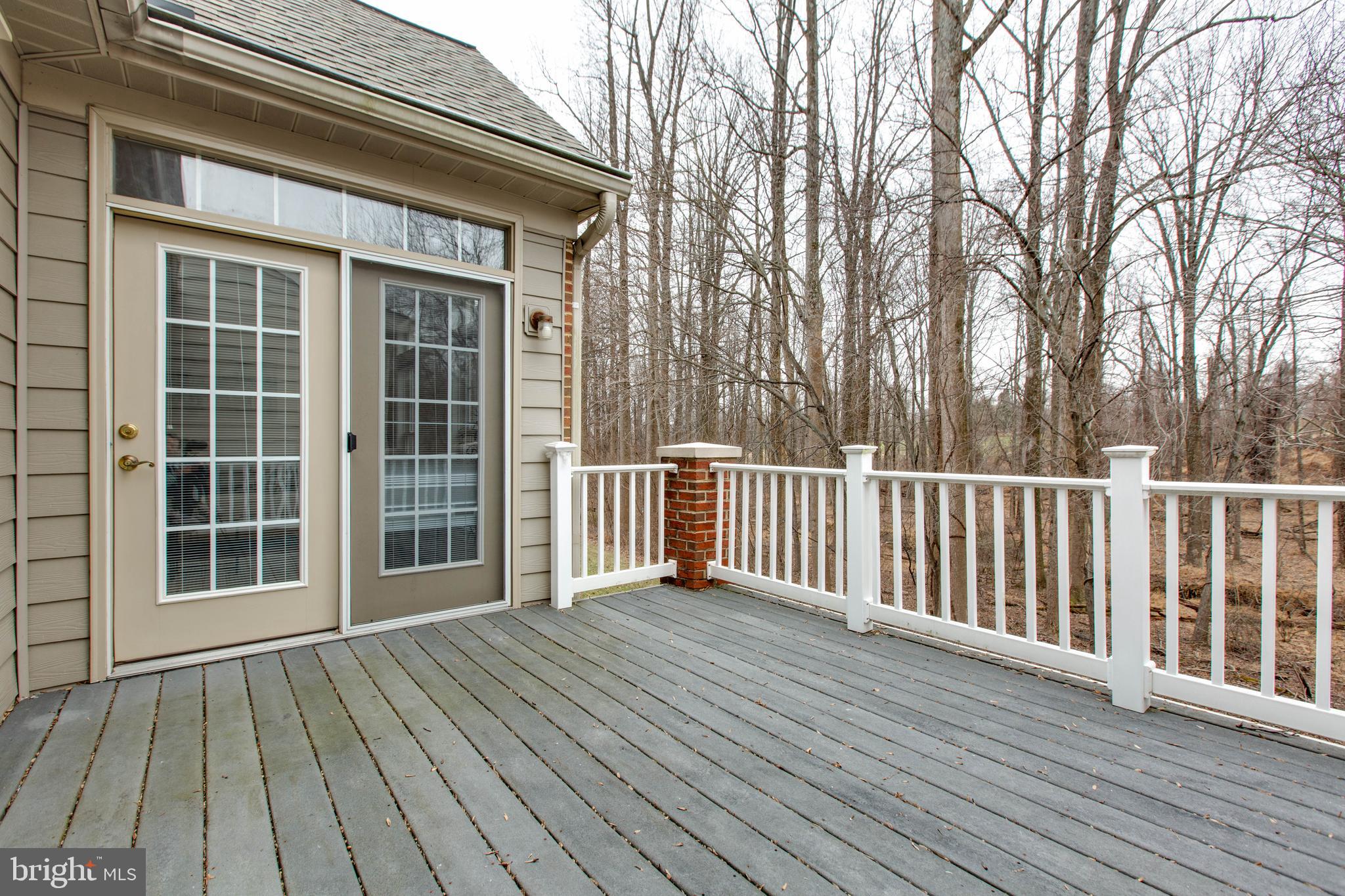 2610 Legends Way Ellicott City, MD 21042 - Photo 34 of 53 a view of backyard with large trees and wooden floor