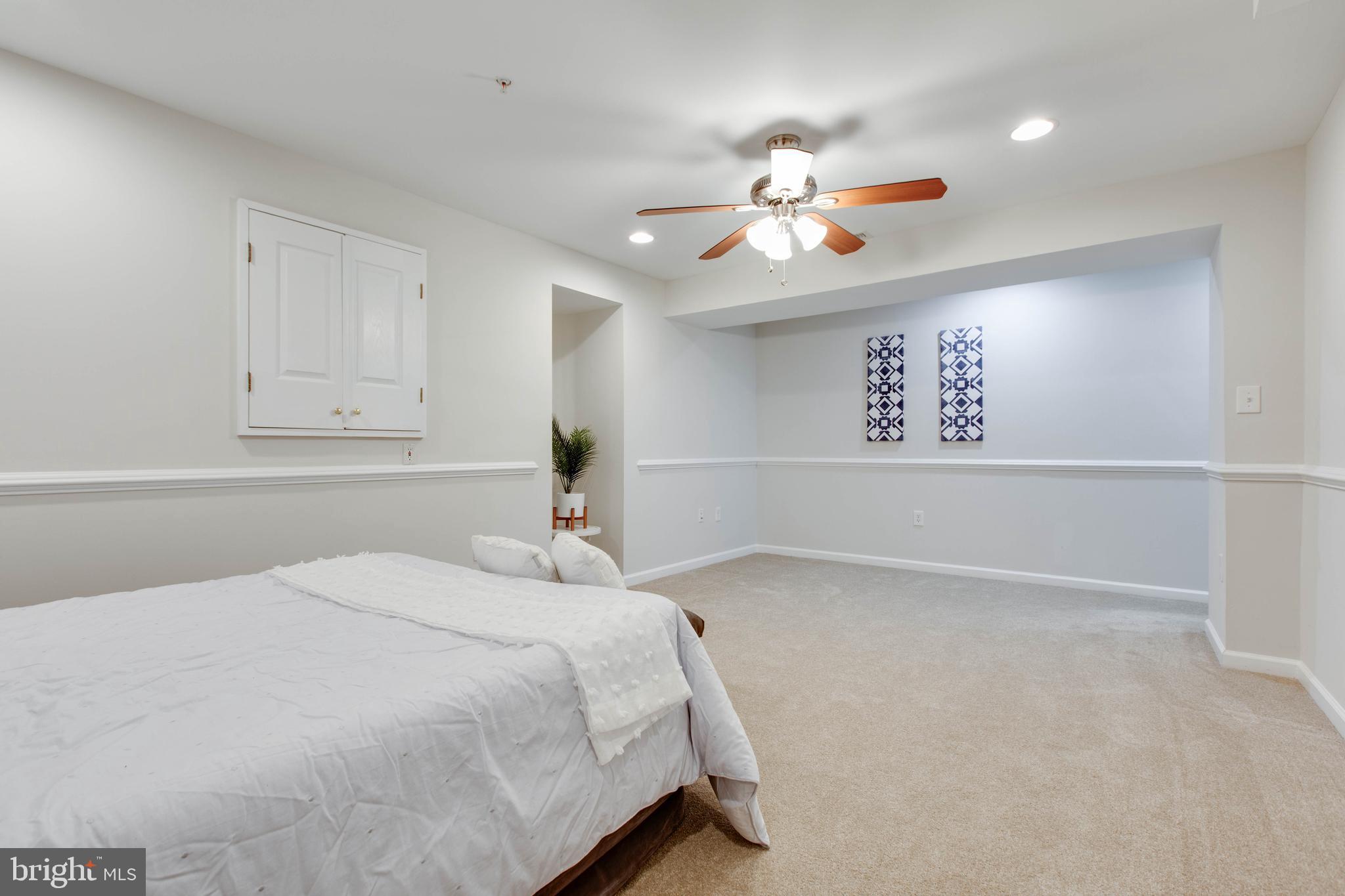 2610 Legends Way Ellicott City, MD 21042 - Photo 47 of 53 a bedroom with a large bed and a chandelier