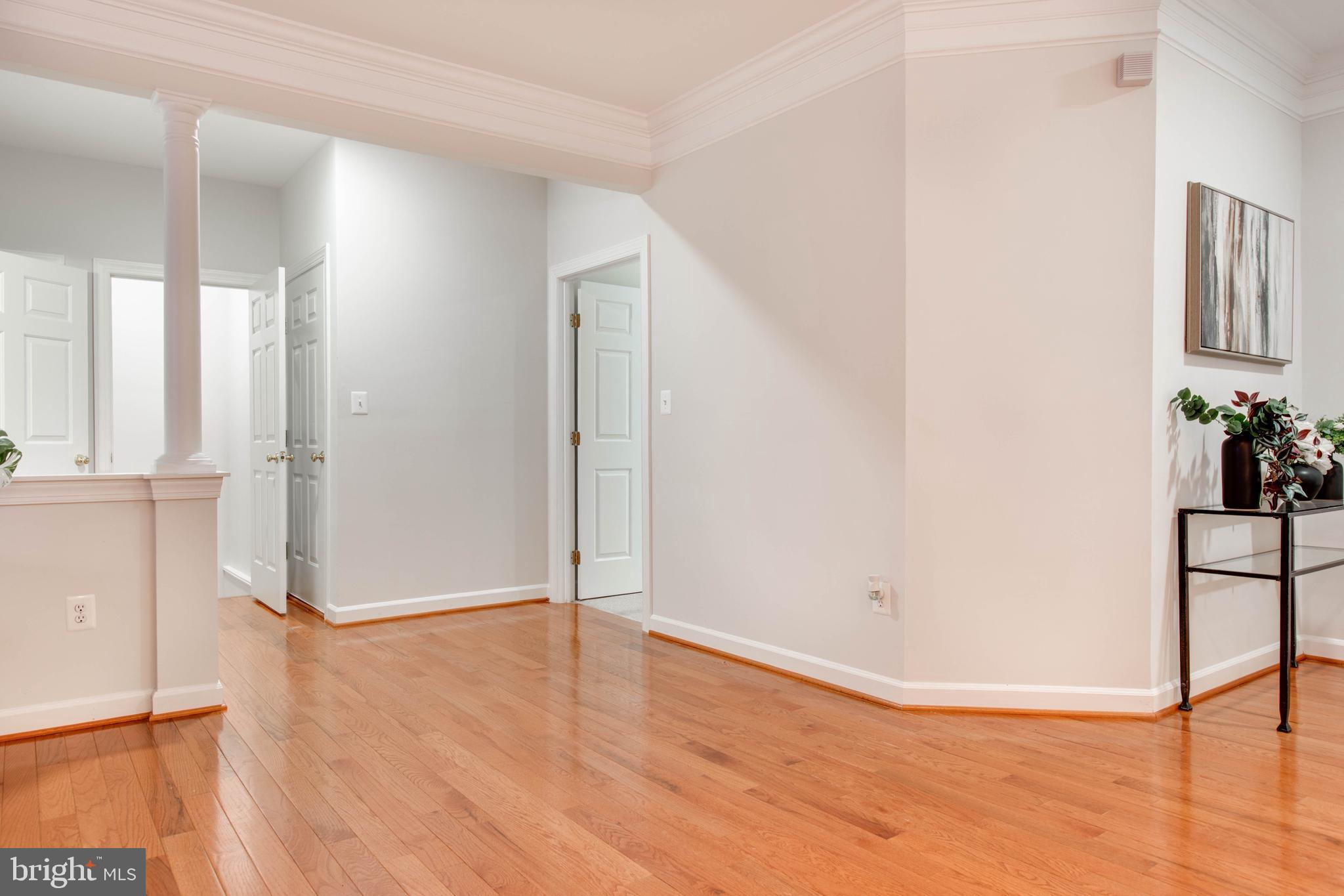 2610 Legends Way Ellicott City, MD 21042 - Photo 7 of 53 an empty room with wooden floor and potted plant