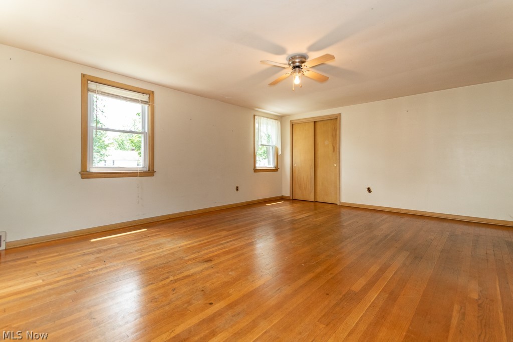 4517 Mackall Road Cleveland, OH 44121 - Photo 38 of 41 Spare room featuring hardwood / wood-style flooring, plenty of natural light, and ceiling fan