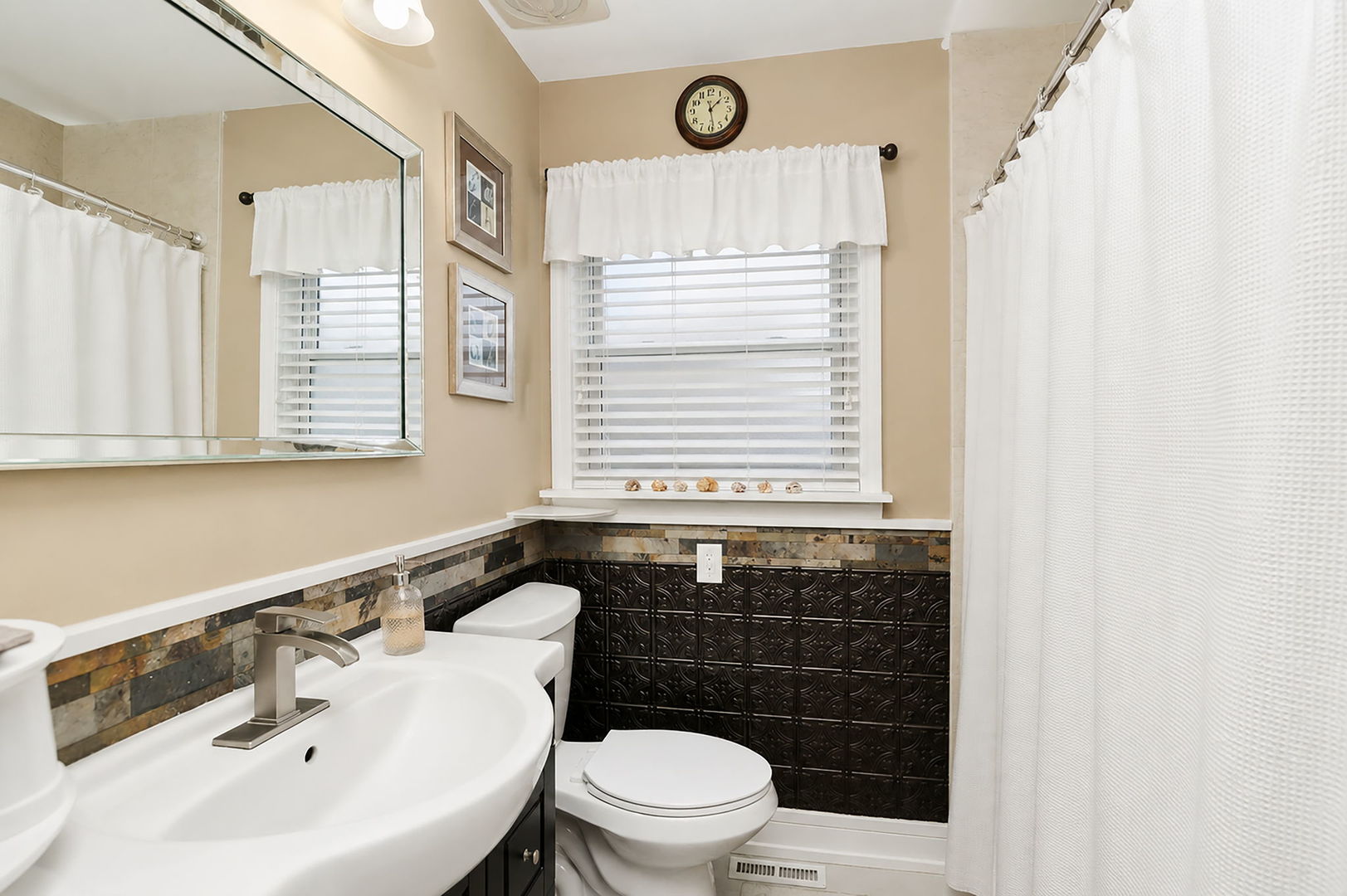 115 Rose Avenue Addison, IL 60101 - Photo 9 of 28 a bathroom with a sink a toilet and a window