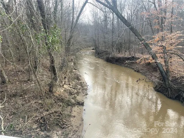 a view of a yard with wooden fence