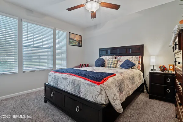 a bedroom with a bed and a chandelier