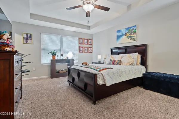 a bedroom with a bed and a chandelier