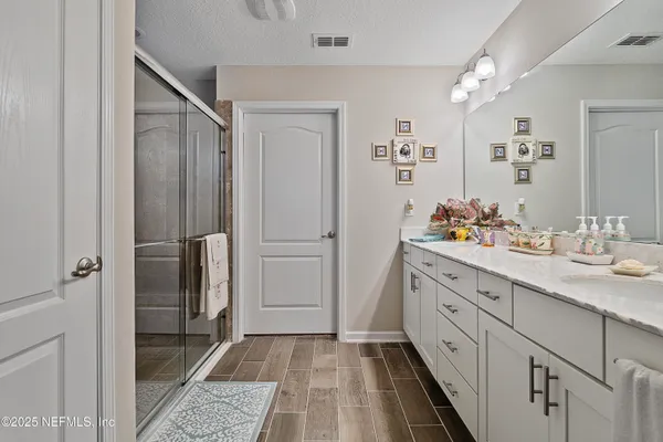 a bathroom with a double vanity sink and mirror