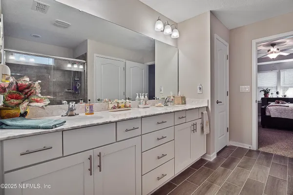 a bathroom with double sink and a mirror