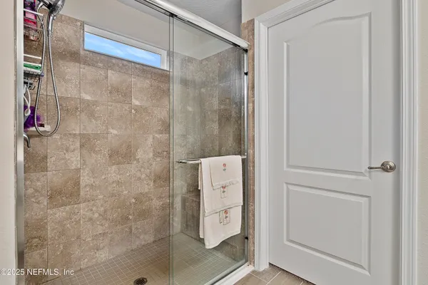 a bathroom with a shower and a sink