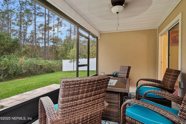 a view of a patio with a table chairs and a backyard