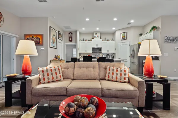 a living room with furniture and a lamp