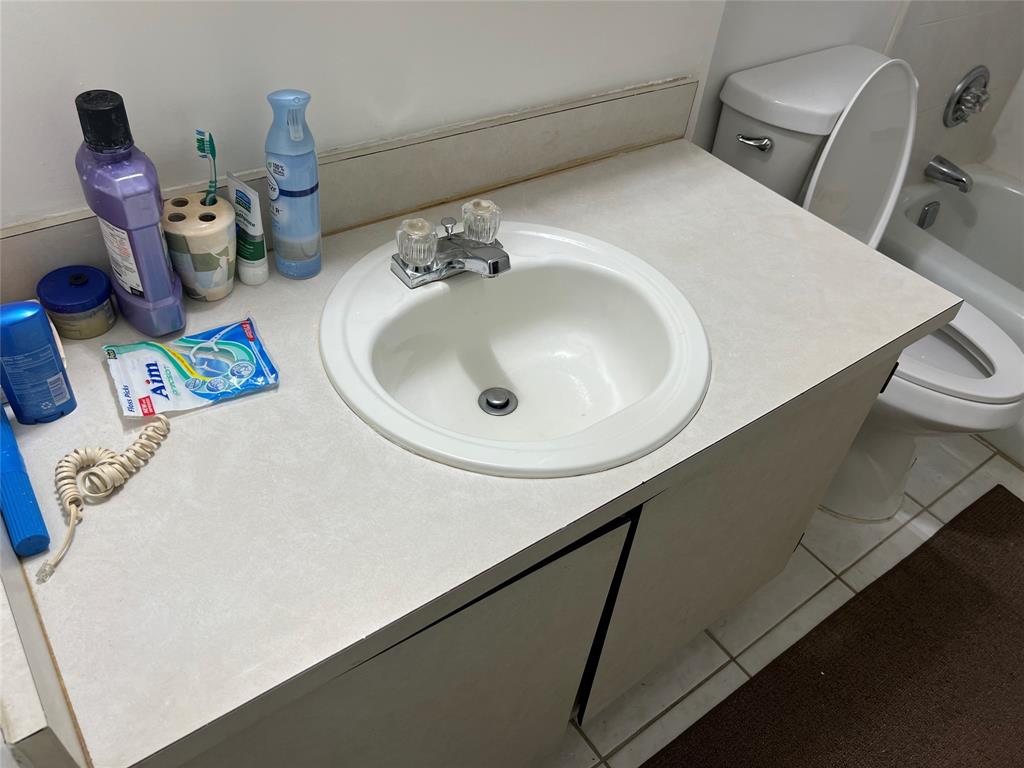 3140 Holiday Springs Boulevard, Unit 109 Margate, FL 33063 - Photo 14 of 26 a bathroom with a sink and a mirror