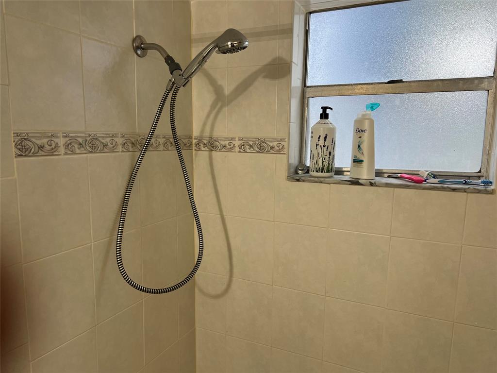 3140 Holiday Springs Boulevard, Unit 109 Margate, FL 33063 - Photo 15 of 26 a bathroom with a sink and a mirror
