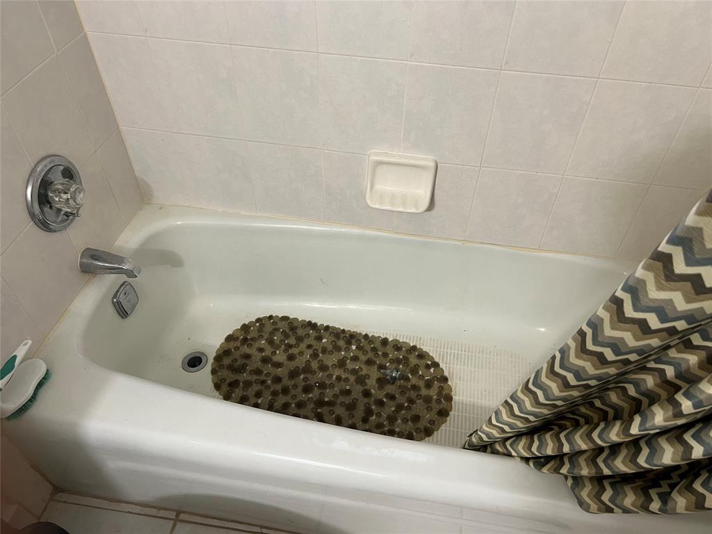 3140 Holiday Springs Boulevard, Unit 109 Margate, FL 33063 - Photo 16 of 26 a bathroom with a bathtub and a shower