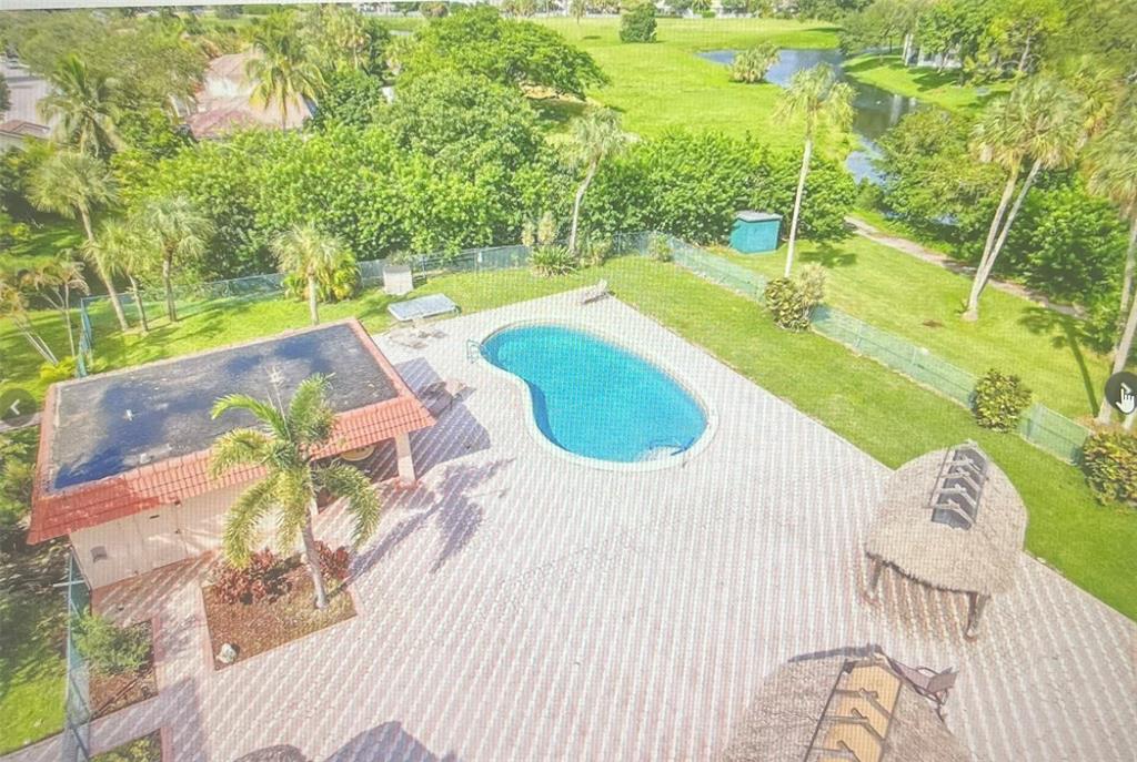 3140 Holiday Springs Boulevard, Unit 109 Margate, FL 33063 - Photo 26 of 26 a view of a swimming pool with a yard