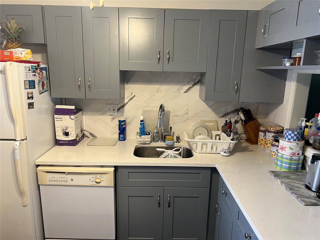 3140 Holiday Springs Boulevard, Unit 109 Margate, FL 33063 - Photo 5 of 26 a kitchen with a sink and cabinets