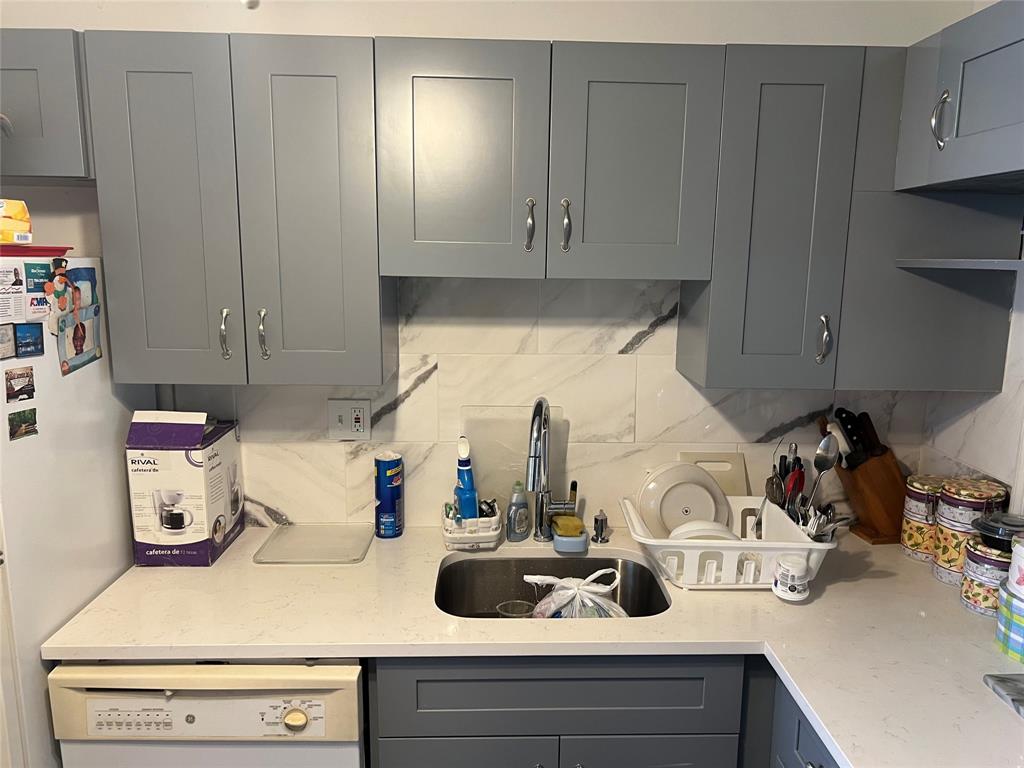 3140 Holiday Springs Boulevard, Unit 109 Margate, FL 33063 - Photo 7 of 26 a kitchen with a sink and cabinets