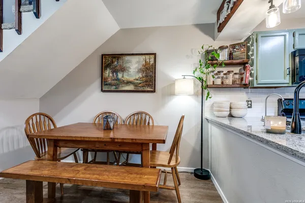 a dining room with furniture and wooden floor
