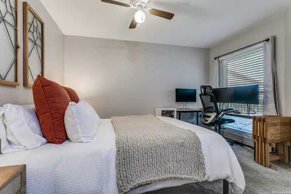 a bedroom with a bed and flat screen tv
