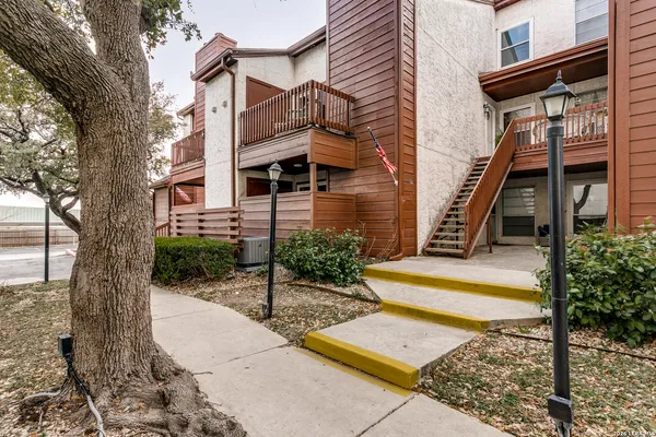 a view of a building with stairs and a tree