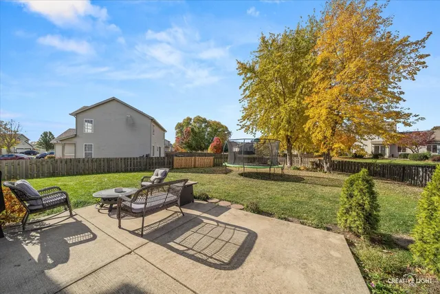 a view of a patio with garden and furniture